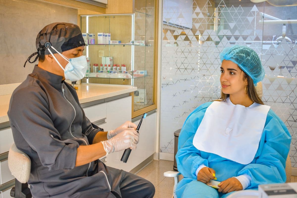 tooth extraction aftercare Belapur dentist explaining brushing to patient in clinic