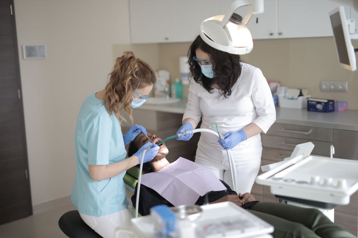 dental filling CBD Belapur dentist and assistant treating patient in modern clinic