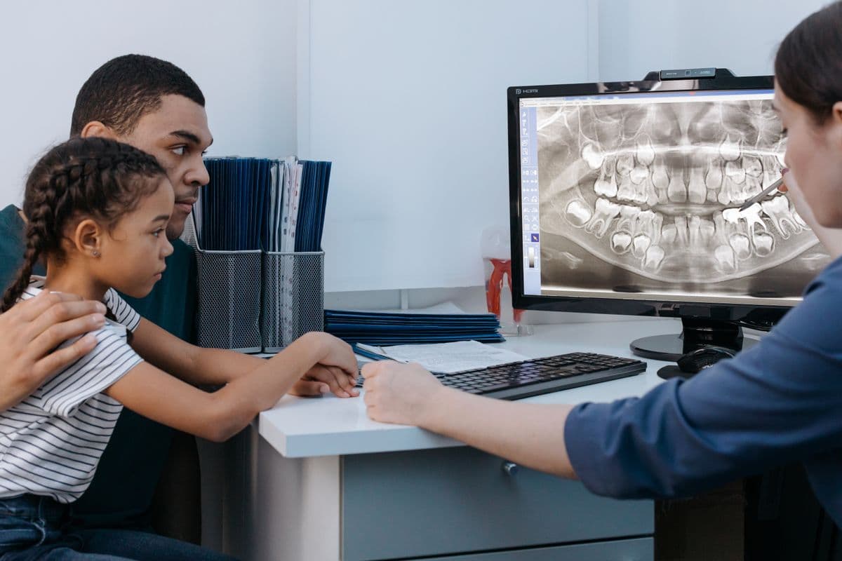 family dentist CBD Belapur parent and child reviewing dental X-ray