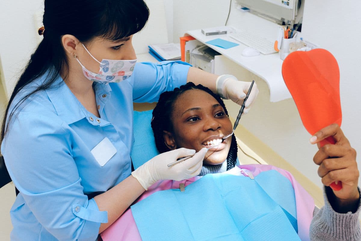 Gum disease treatment Belapur — dentist examining patient gums at CBD Belapur clinic