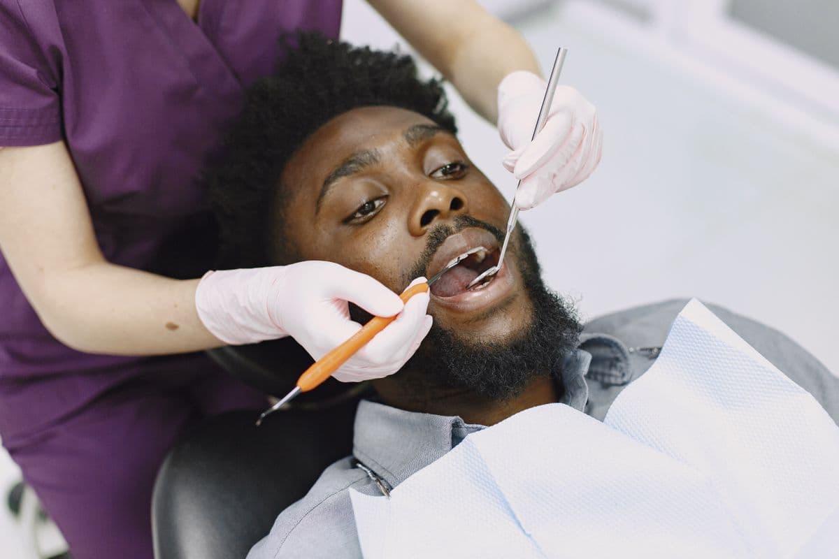 gum grafting Belapur dentist examining patient gums at dental clinic
