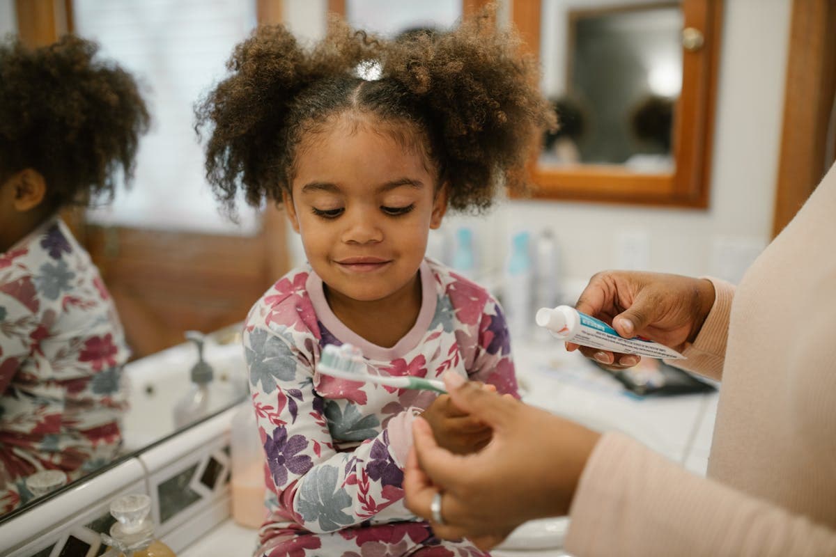 kids dentist CBD Belapur — mother and child brushing teeth together at home