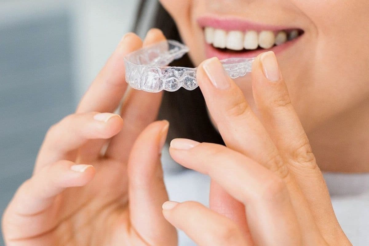 night guard for teeth grinding CBD Belapur clear dental splint held by patient