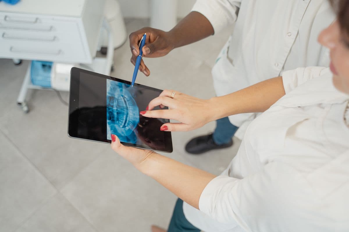 tooth abscess treatment Belapur dentist reviewing dental x-ray with patient