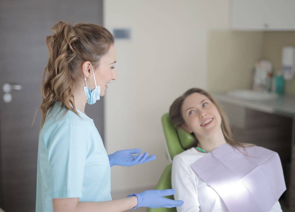 tooth sensitivity CBD Belapur dentist talking to patient in clinic
